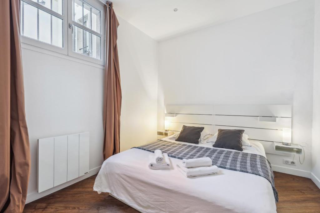 Łóżko lub łóżka w pokoju w obiekcie Appartement charmant et lumineux en plein cœur de Paris