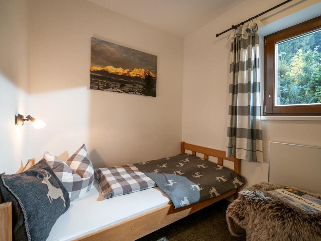 A bed or beds in a room at Chalet Kitzalm