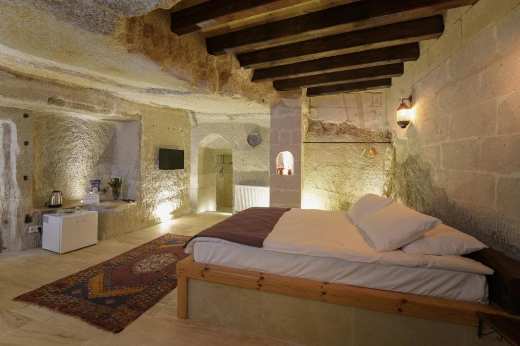 Postel nebo postele na pokoji v ubytování My Cave Suites