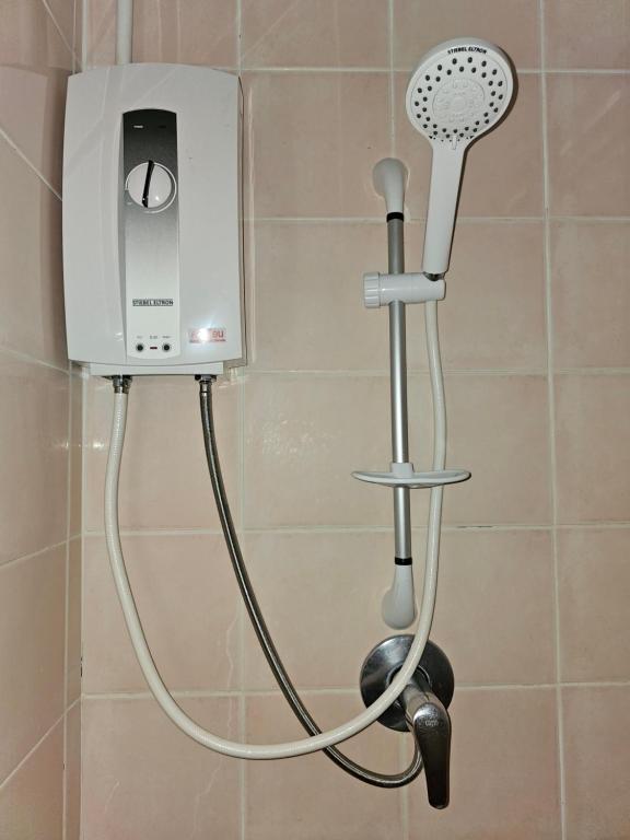 a shower with a blow dryer in a bathroom at Lanta MP Place in Ko Lanta