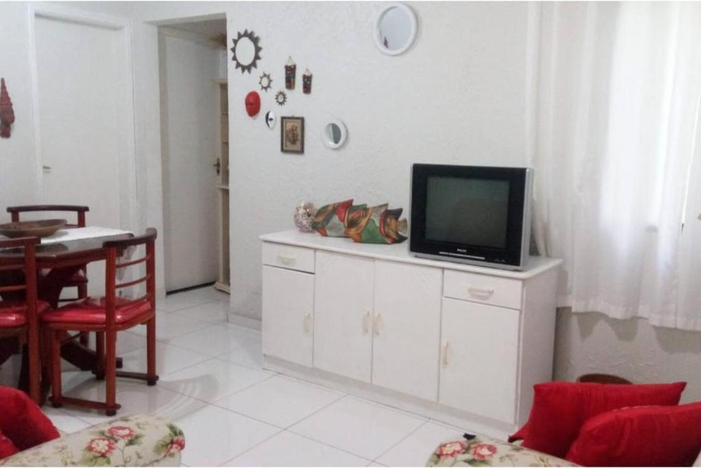 een woonkamer met een televisie op een witte kast bij LA05-Bertioga, Próximo ao SESC, Riviera, Vista Linda, Indaiá in Bertioga