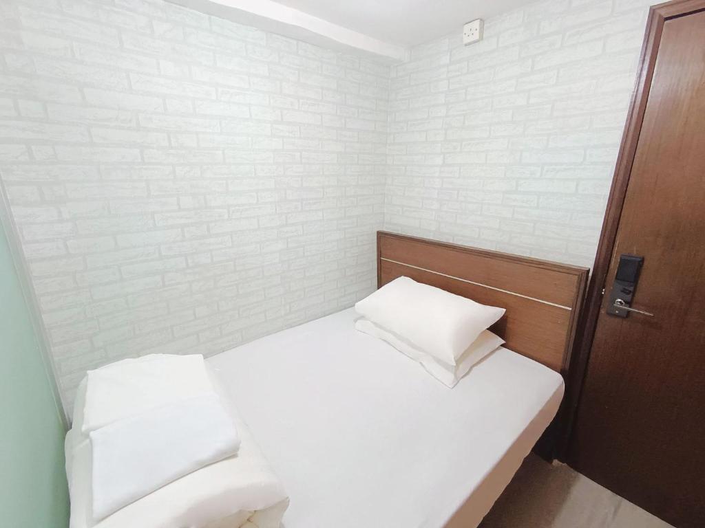 Postel nebo postele na pokoji v ubytování Tempo Inn West Kowloon HSR Station