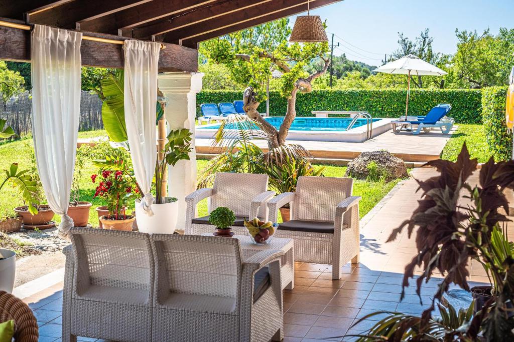 a patio with a table and chairs and a pool at Villa ANGELS in Pollença