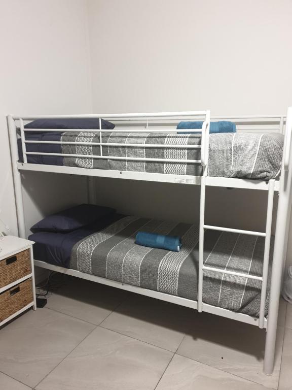 a bunk bed with towels and a mattress at Hostel-Style GUESTHOUSE - for 18-40yrs in Caloundra