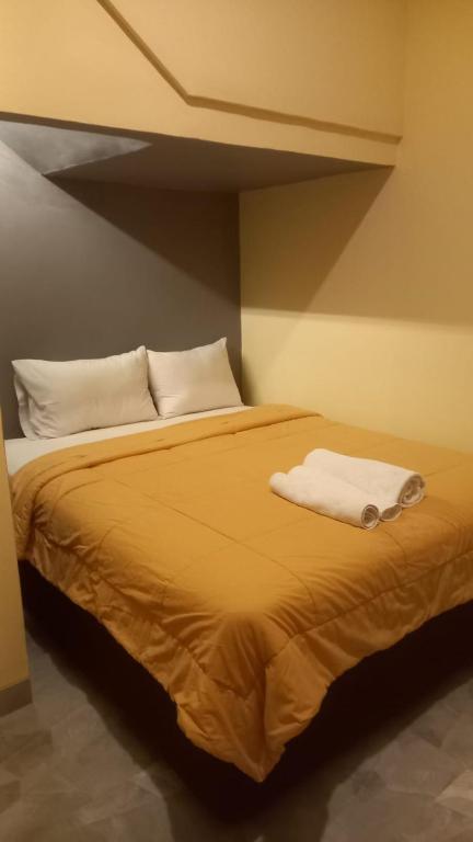 Postel nebo postele na pokoji v ubytování Rumah WJ rooms and suites