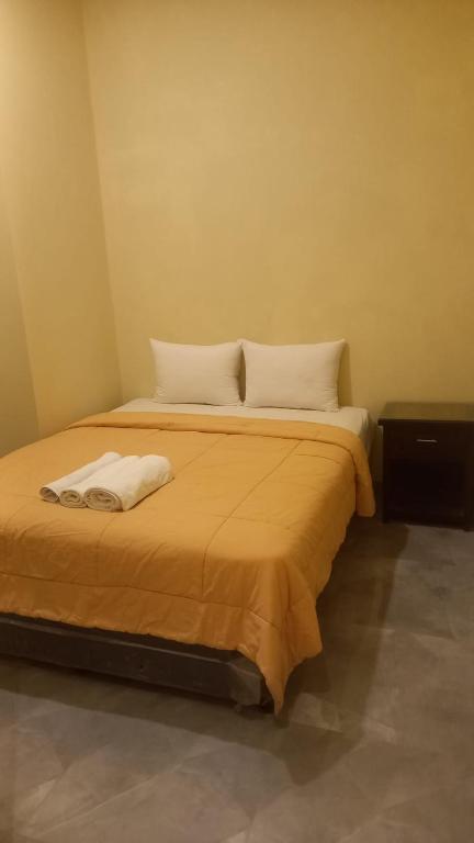 Postel nebo postele na pokoji v ubytování Rumah WJ rooms and suites