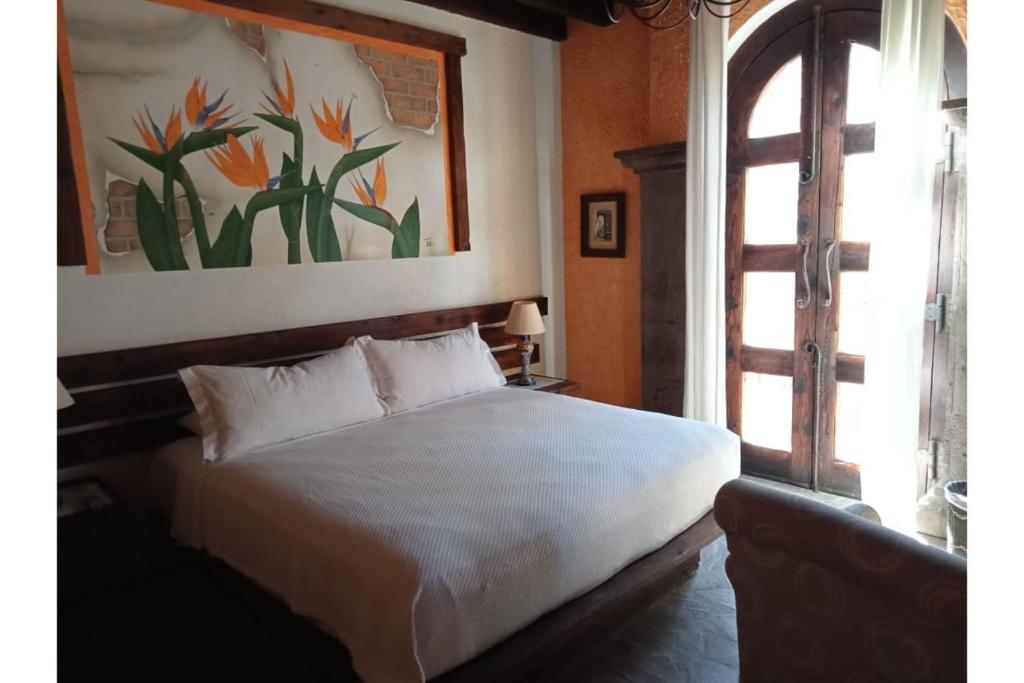 Postel nebo postele na pokoji v ubytování Hotel Boutique Posada De Las Flores Loreto