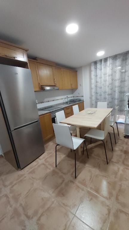 a kitchen with a table and chairs and a refrigerator at Casa Majo Valdelinares VUTE-23-002 in Valdelinares