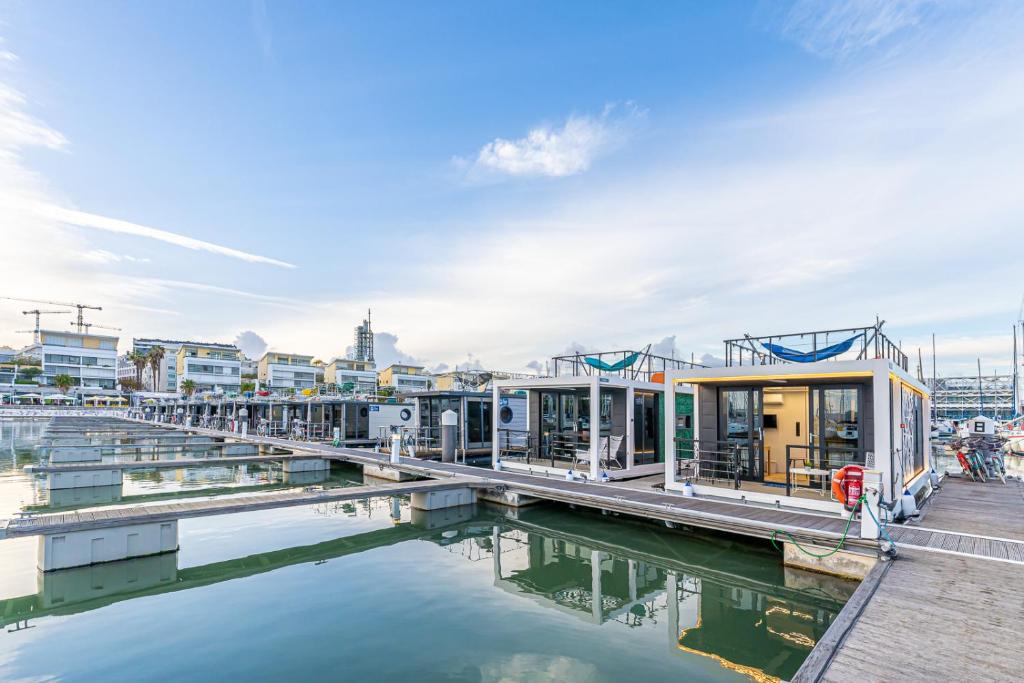 a group of buildings next to a body of water at The Homeboat Company Parque das Nações-Lisboa in Lisbon