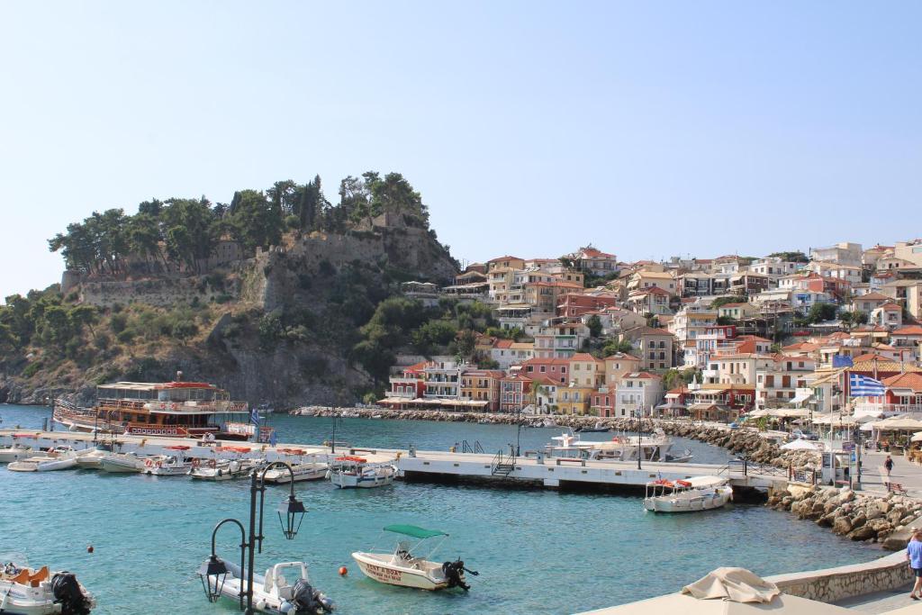 a group of boats docked in a harbor with houses at PARALIA Souli di mare in Parga