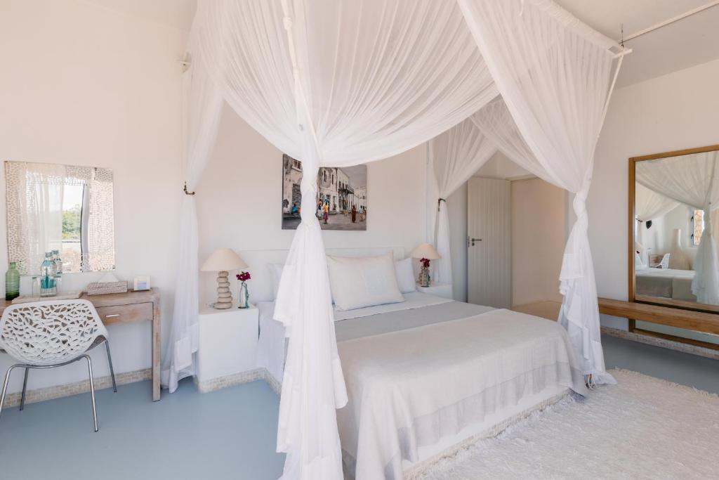 Postel nebo postele na pokoji v ubytování Villa Santorini