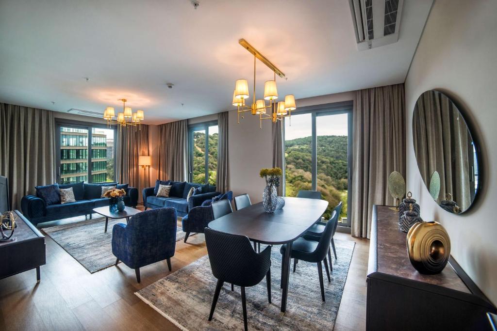 a living room with a table and chairs at Radisson Residences Vadistanbul in Istanbul