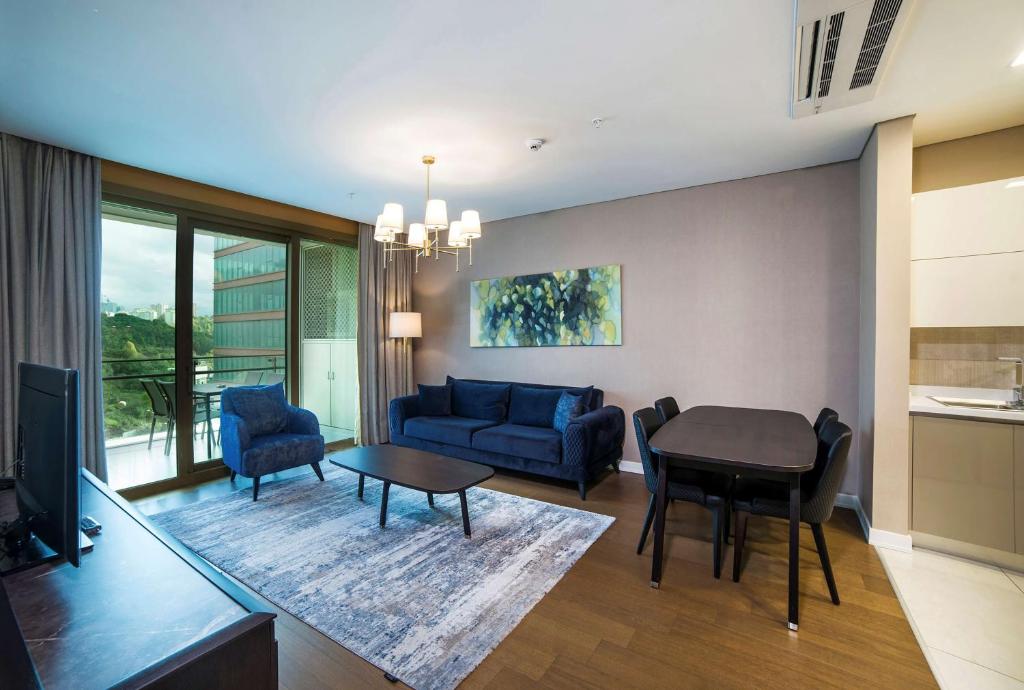a living room with a couch and a table at Radisson Residences Vadistanbul in Istanbul