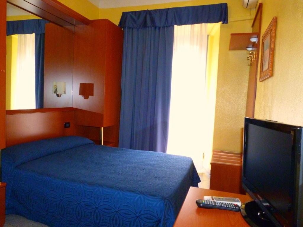 Postel nebo postele na pokoji v ubytování Hotel Aurora