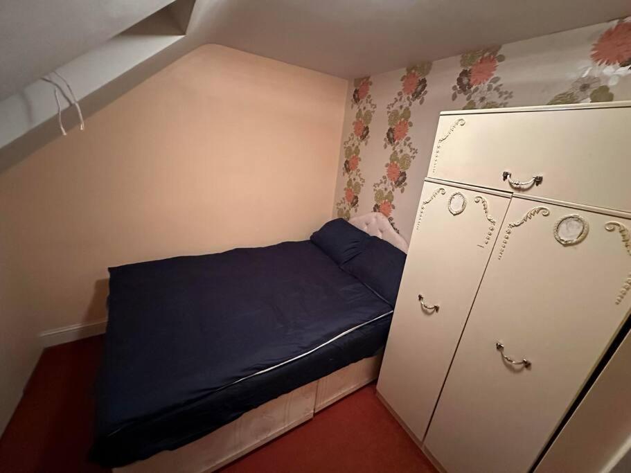 ロンドンにあるSweet dream 4のベッド1台とキャビネット付きの小さな部屋です。