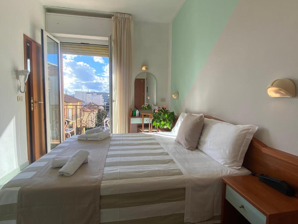 Łóżko lub łóżka w pokoju w obiekcie Hotel Villa Caterina