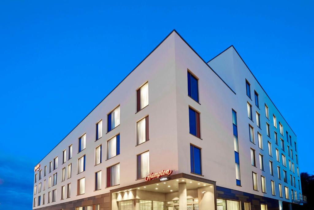 a white building with a blue sky in the background at Hampton by Hilton Bournemouth in Bournemouth