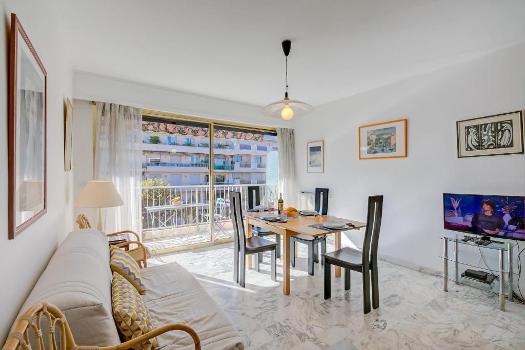 ein Wohnzimmer mit einem Sofa und einem Tisch in der Unterkunft Appartement Le Fabiola - Happy Rentals in Antibes