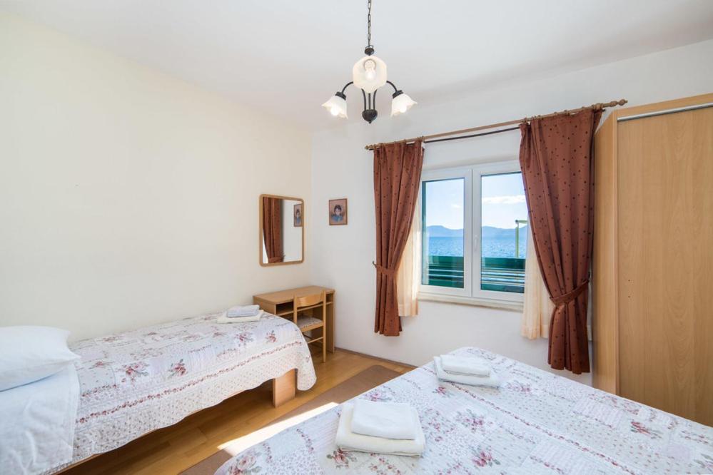 Postel nebo postele na pokoji v ubytování Apartments Dominko