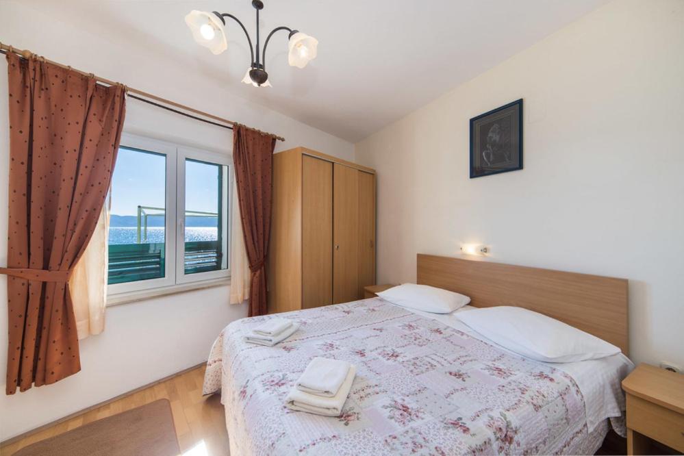 Postel nebo postele na pokoji v ubytování Apartments Dominko