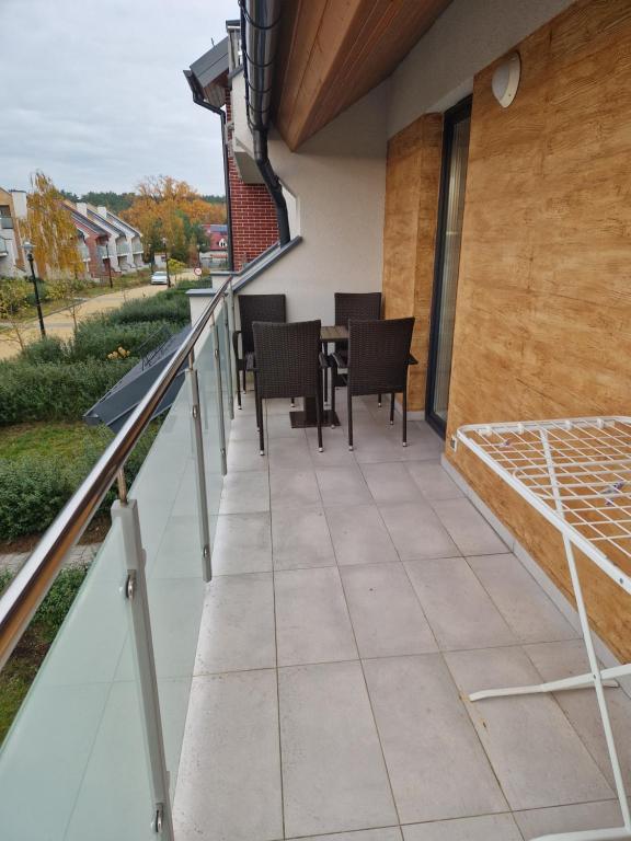 a balcony with a table and chairs on it at sandra1 in Jantar