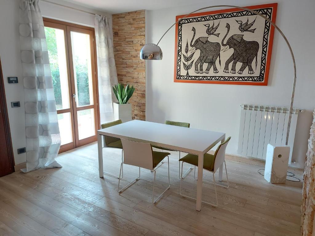 ein Esszimmer mit einem weißen Tisch und Stühlen in der Unterkunft Il Melograno in Toscana in Castelfranco di Sopra