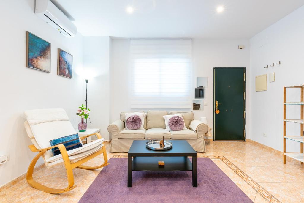 a living room with a couch and a table at WintowinRentals Great Apartment, Amazing Location in Parque Mediterráneo in Málaga