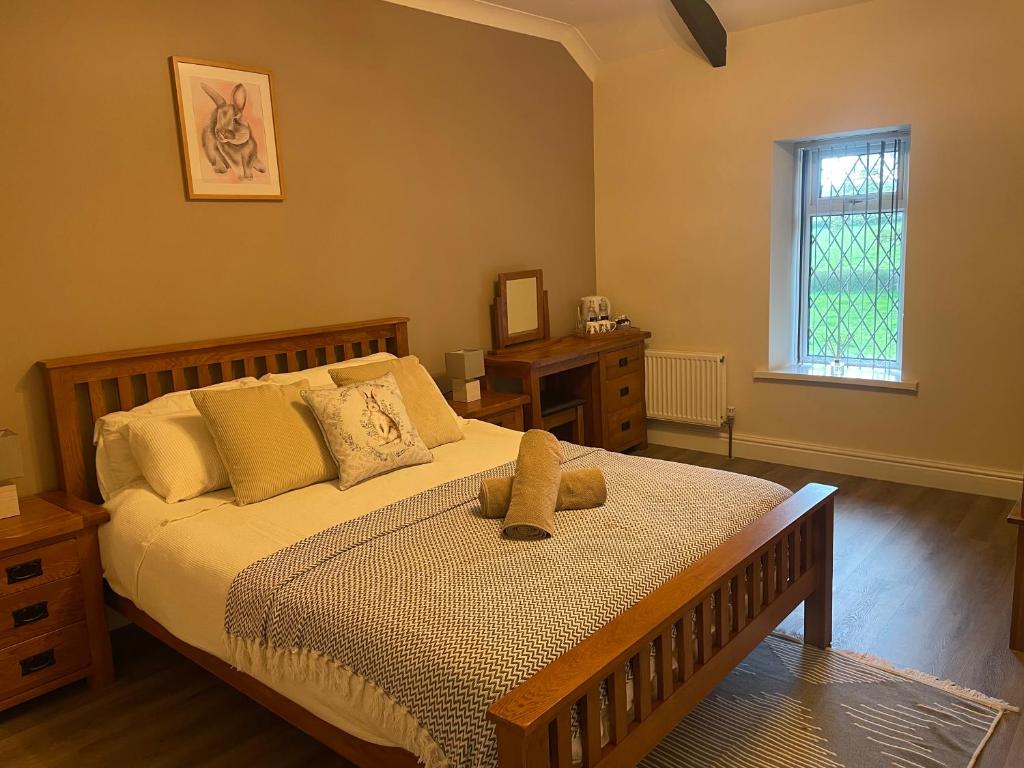 a bedroom with a bed with two teddy bears on it at The Cottage Inn in Llandeilo