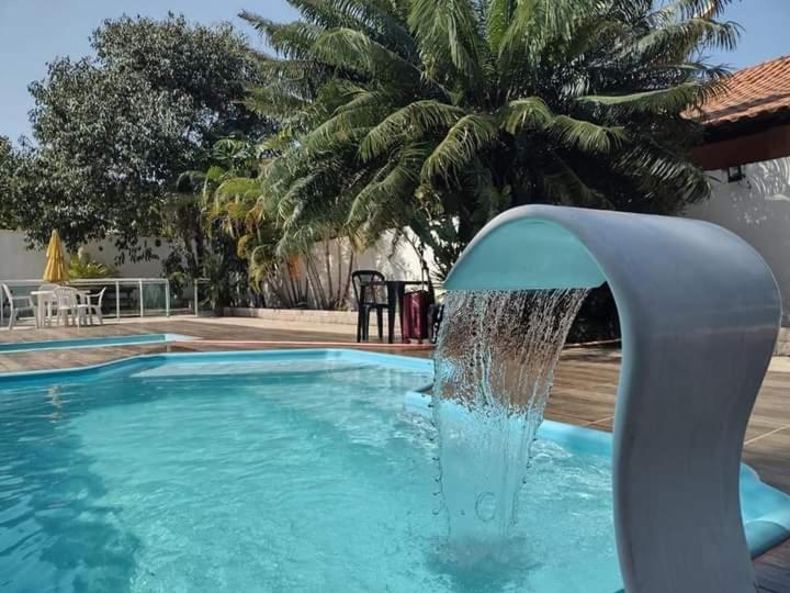 a water fountain in a swimming pool at Pousada Recanto de Praia Seca in Araruama