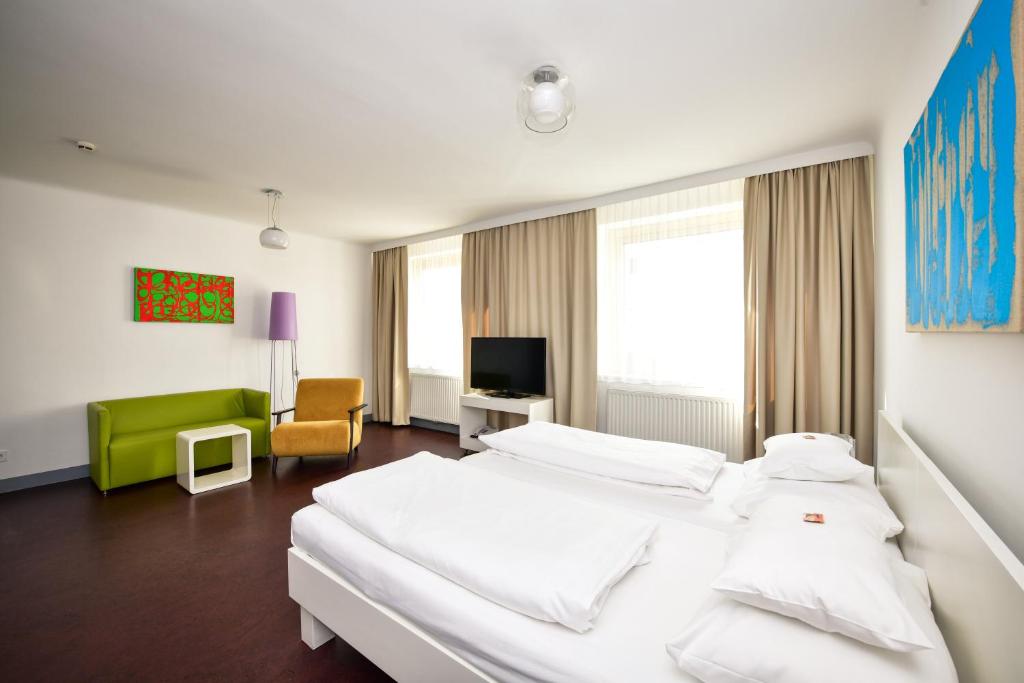Postel nebo postele na pokoji v ubytování Stanys - Das Apartmenthotel
