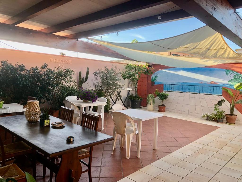 a patio with tables and chairs in a restaurant at Casa Bea B&B in Tortolì