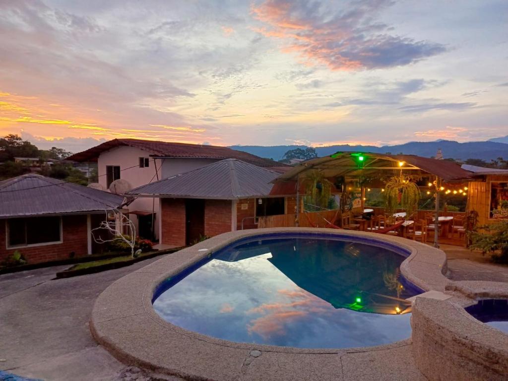 a swimming pool in the middle of a house at Hostería Cacique Wasi in Puyo