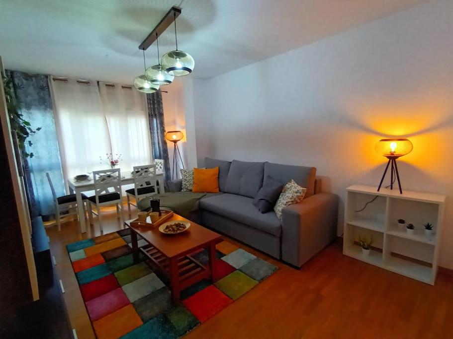 a living room with a couch and a table at Acogedor Apartamento con Terraza in Vimianzo