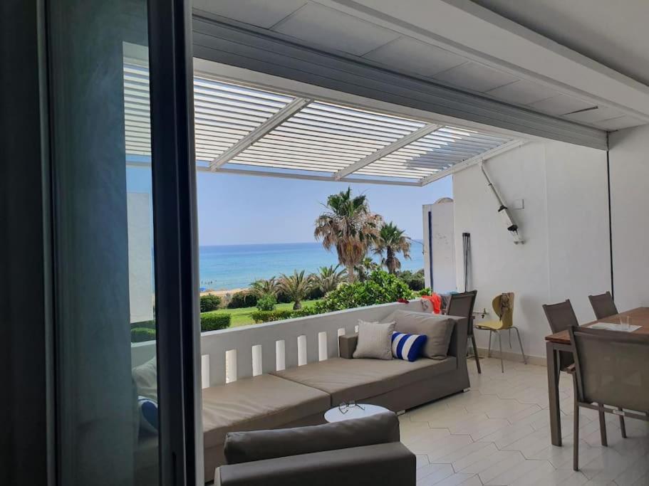 a living room with a couch and a view of the ocean at bel appartement vue sur mer in Nabeul