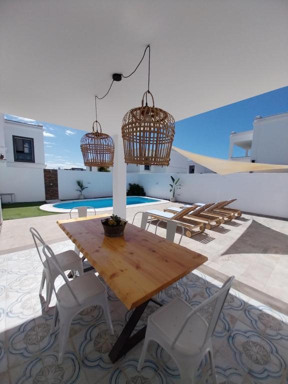 a wooden table and chairs on a patio at Villa Stefi in Playa Blanca
