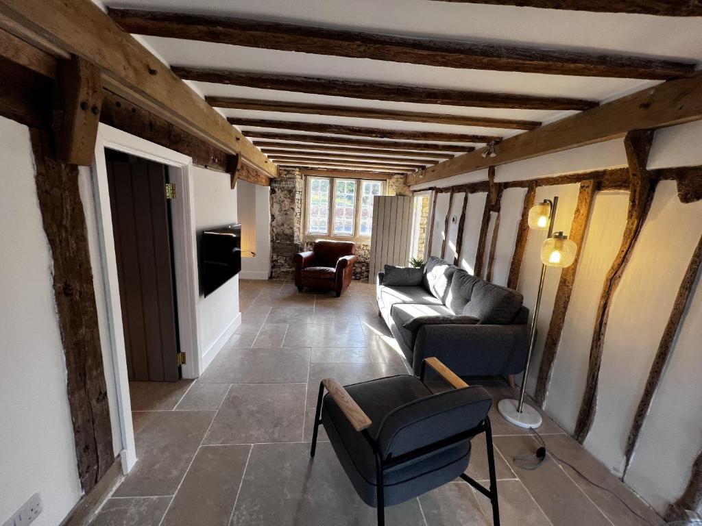 a living room with a couch and a chair at Seven Abbey Lane in Southam