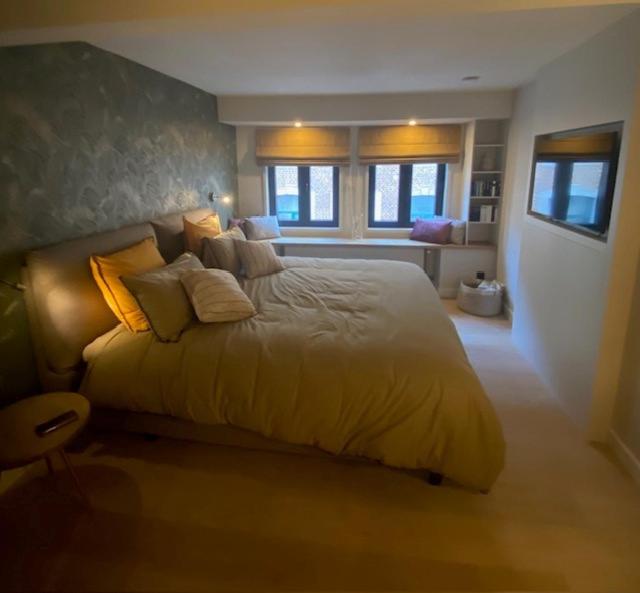 a bedroom with a large bed with yellow sheets and pillows at Maison de ville - 4 personnes - Ô coeur de Spa in Spa