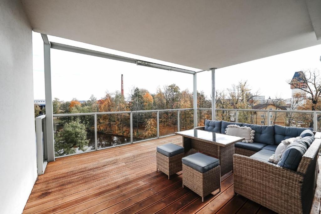 d'un balcon avec un canapé et une table sur une terrasse. dans l'établissement Riverside Apartments, à České Budějovice
