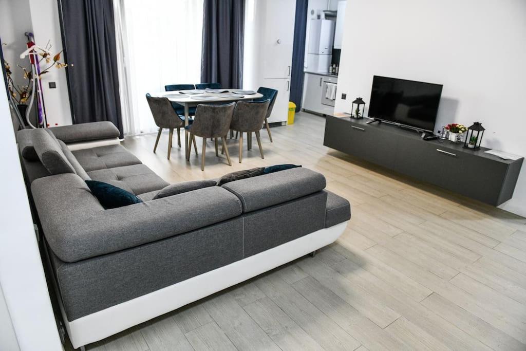 a living room with a couch and a table at MH Residence in Cluj-Napoca