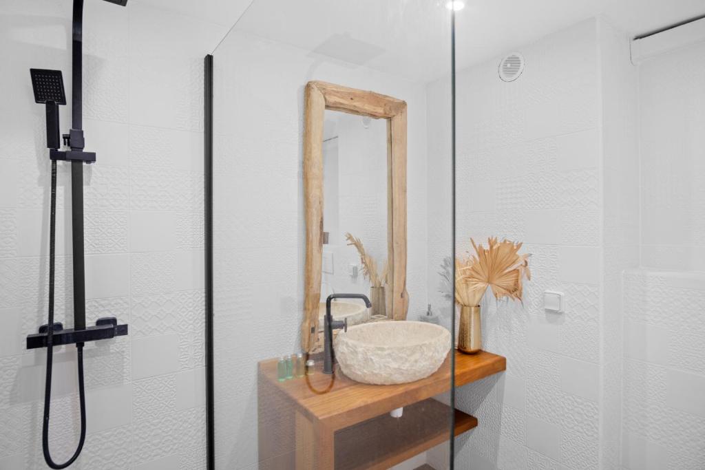 a bathroom with a sink and a mirror at Studio Sunshine in Le Diamant