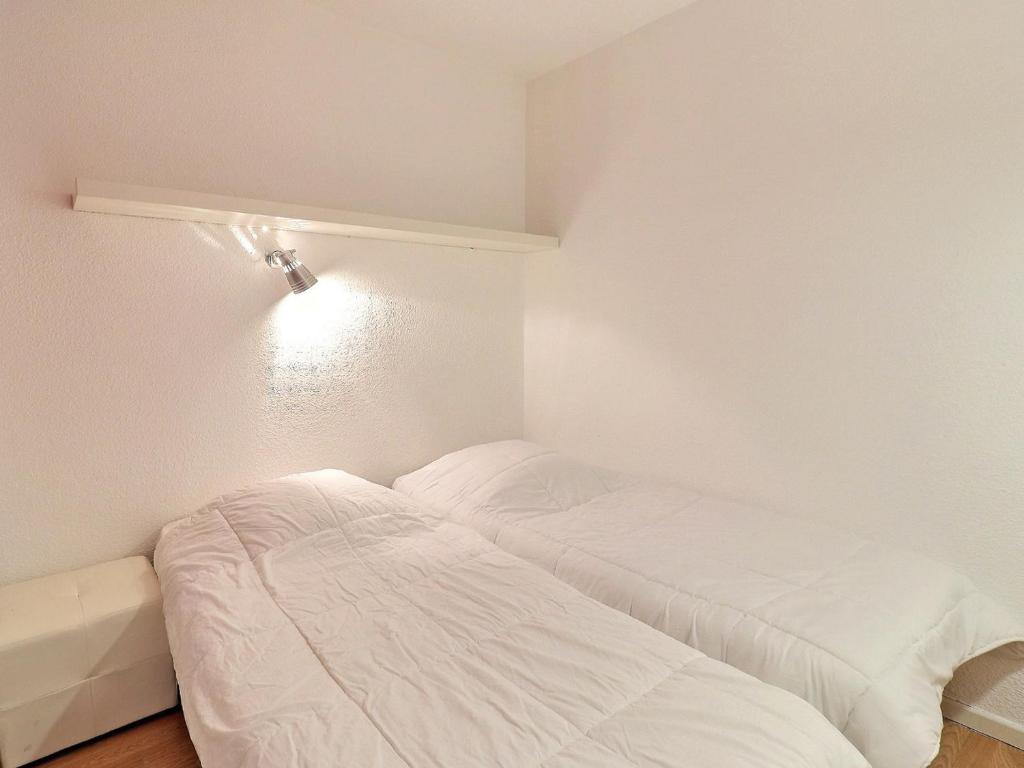 biały pokój z łóżkiem i lampką w obiekcie Appartement La Tania 4 pers, skis aux pieds, 2 pièces, balcon, résidence Grand Bois A - FR-1-182A-19 w Courchevel