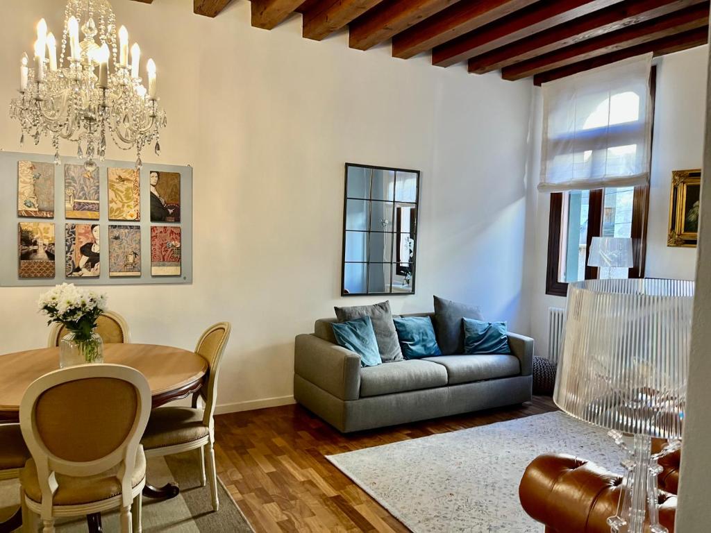 a living room with a couch and a table at SANTA CATERINA: charming apartment TREVISO in Treviso