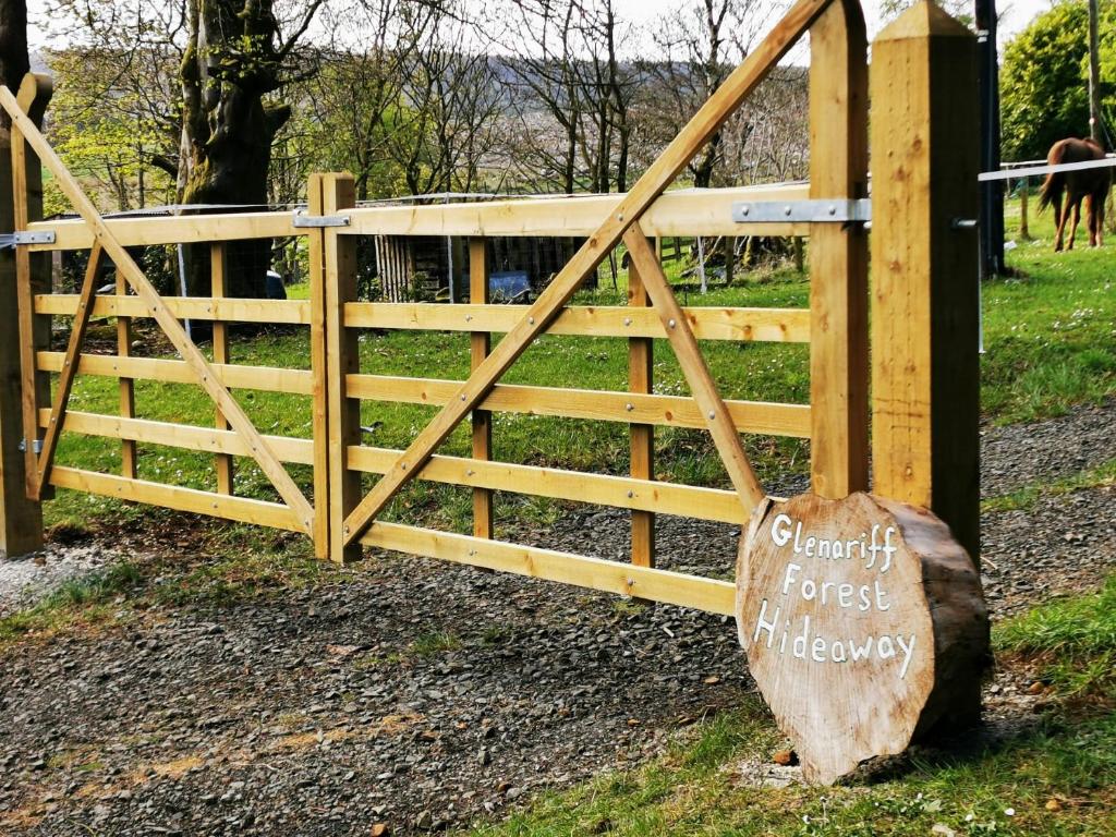 a wooden gate with a sign in front of it at Glenariff Forest Hideaway in Glenariff