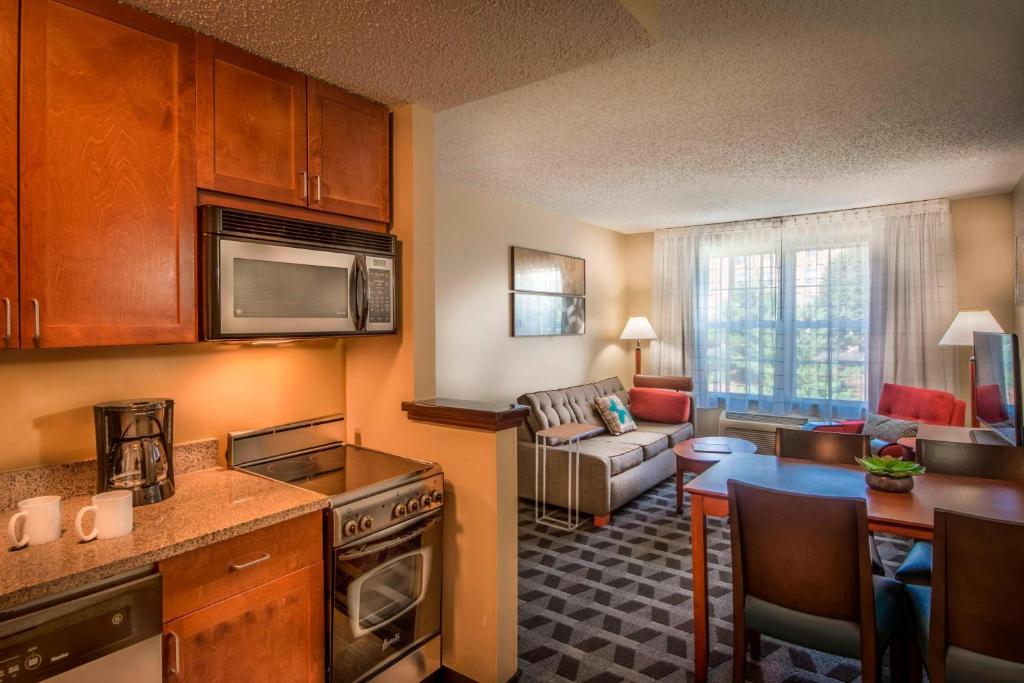 a kitchen and a living room with a couch at TownePlace Suites by Marriott Baltimore BWI Airport in Linthicum Heights