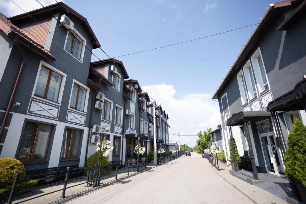 an empty street in a town with buildings at Hotel Kopa - Zhovkva in Zhovkva