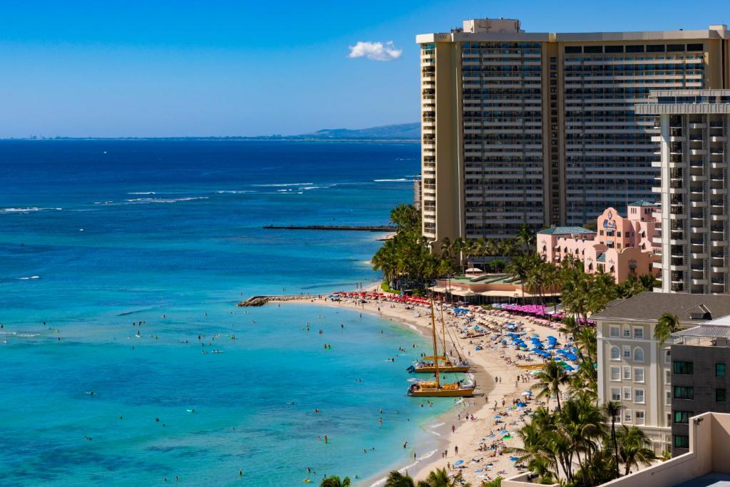 an aerial view of a beach with people and the ocean at Ocean Front Spectacular Condo in Honolulu