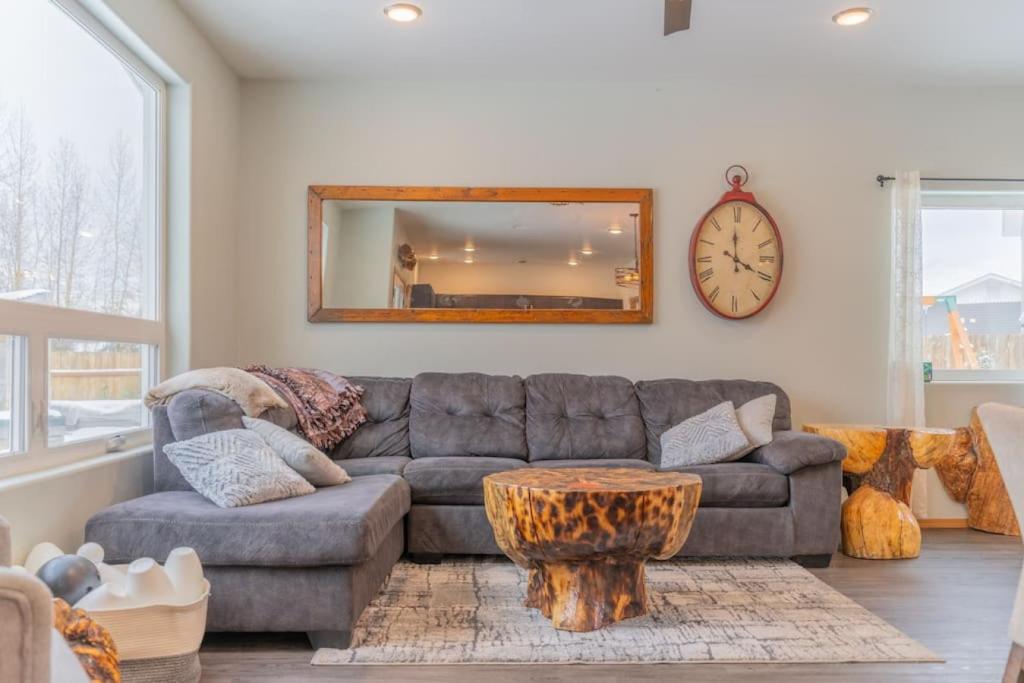a living room with a couch and a mirror at Charming Family Haven On the Loop in Fairbanks