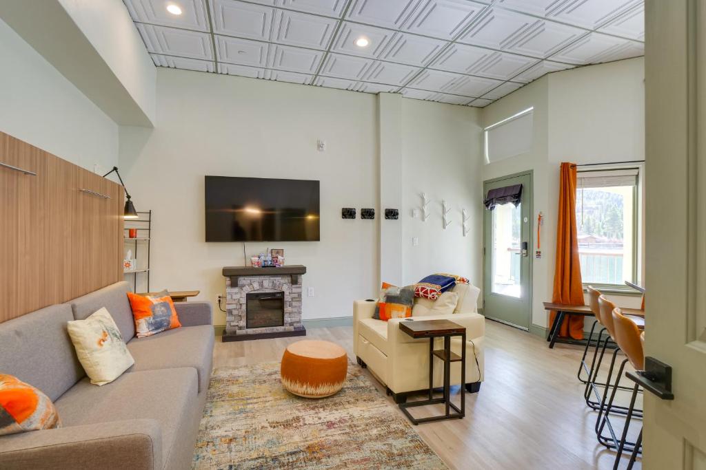 a living room with a couch and a fireplace at Mtn and Lake Views Chic Keystone Studio in Keystone