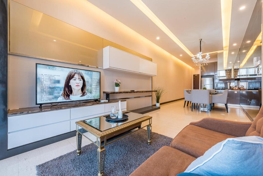 a living room with a flat screen tv on a wall at Dorsett Residence Kuala Lumpur 帝盛公寓 Bukit Bintang in Kuala Lumpur