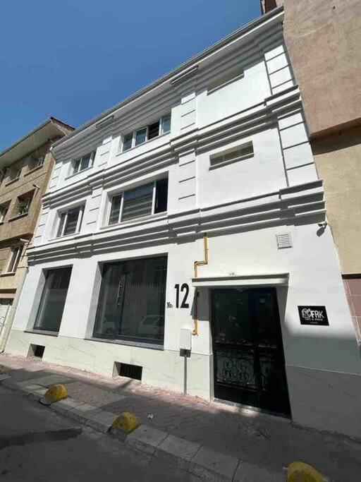 a white building with the number 12 on it at Espark baglar 1+1+ teraslı daire in Eskisehir